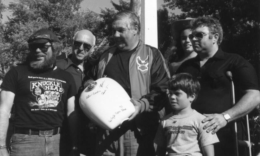 Pictured left to right: Willie G. Davidson, V.P. Styling; Vaughn Beals, C.E.O.; Charles Thompson, President; Marv Yagel with children, Mike and Elizabeth